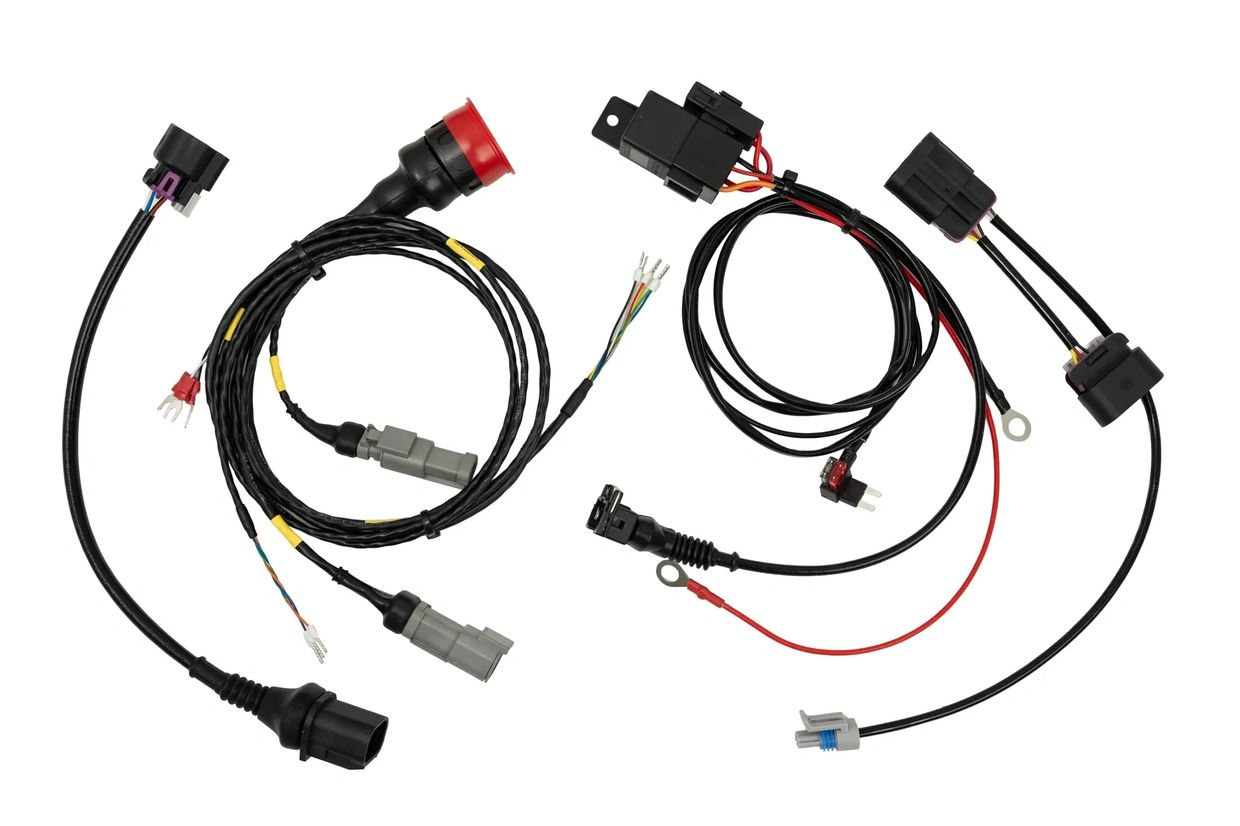 Two automotive wiring harnesses with connectors and colored wires.
