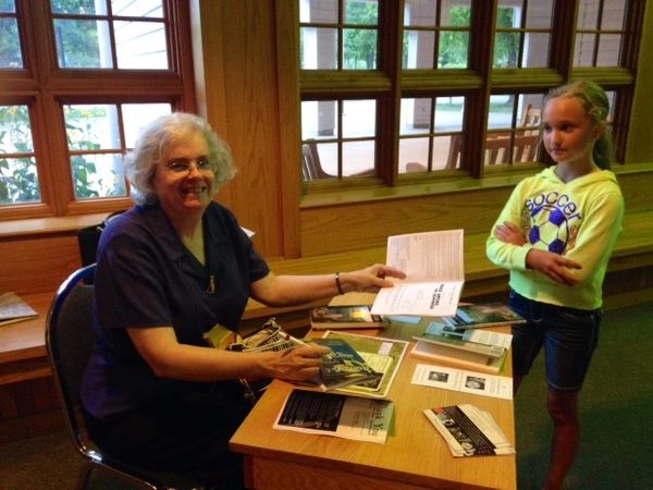Beverly Fisher, Grace Among the Leavings, in New Salem, IL Theatre in the Park of her book. 2014.