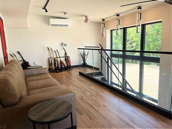 Modern music room with guitars and natural light.