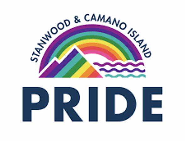 Logo for Stanwood &amp; Camano Island Pride with rainbow and mountain design.