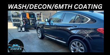 Shiny black car after wash and coating service.