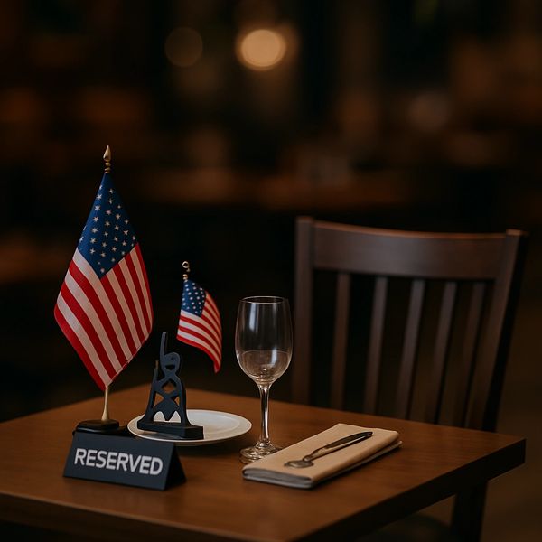 Reserved table with American flags and dining setup.