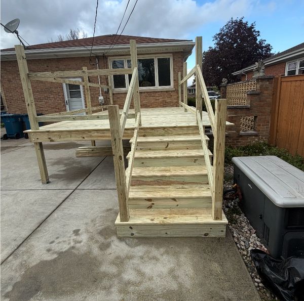 Newly constructed wooden deck and staircase in a residential backyard.