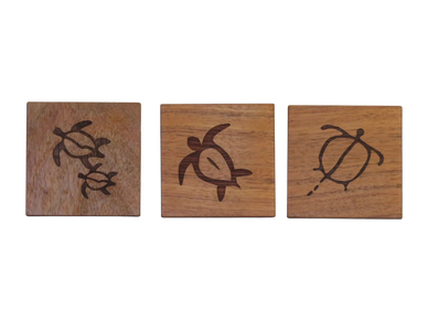three Koa coasters, each engraved with a differen honu turtle design