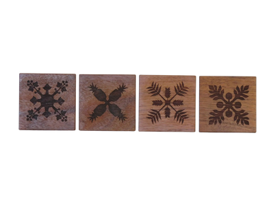 4 Koa quilted coasters engraved with kukui, pineapple, ginger and ulu designs
