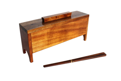 Koa chopstick box with handle and chopsticks arranged in front of it