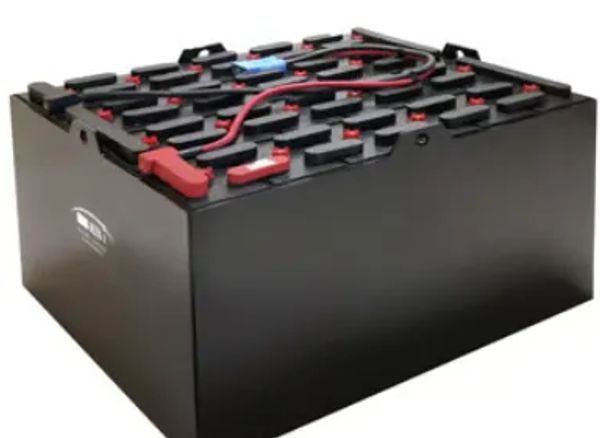 Large black industrial battery with red and blue connectors on top.