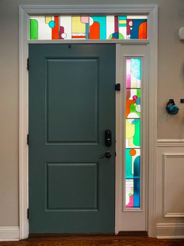 Modern stained glass of colorful fun shapes for entryway front door. Residence in Ambler PA