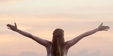 Woman raising arms to sky