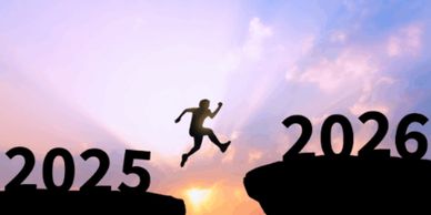 Silhouette of a person jumping from 2025 to 2026 over a gap at sunset.