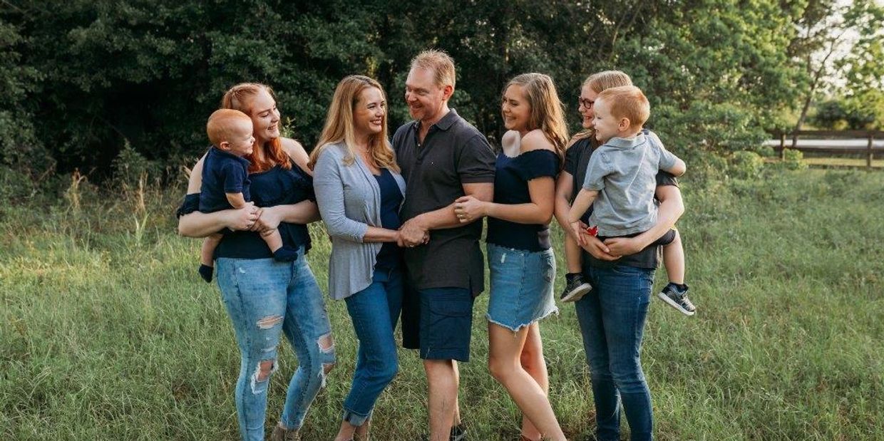 Happy family of seven with insurance agents in Texas providing family insurance coverage and protect