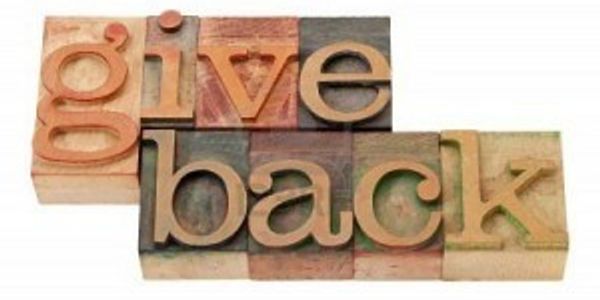 Wooden blocks spelling 'give back'.