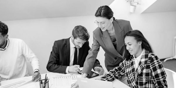 Professionals collaborating on a project in a modern office.