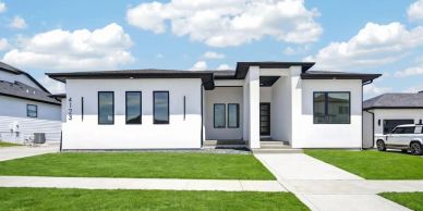 Modern single-story white house with black trim.