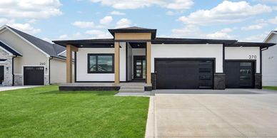 Modern single-story house with a black and white exterior.