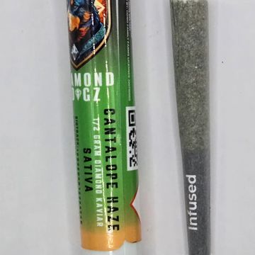 Cannabis pre-roll labeled Diamond OGz Cantaloupe Haze Sativa with an infused joint.