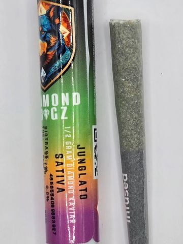 Close-up of a colorful cannabis joint package and a rolled joint.