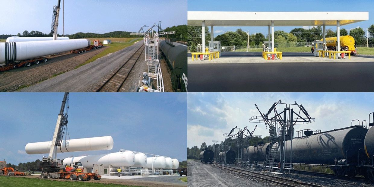 Large capacity fuel tanks at a commercial tank farm alongside a rail spur.