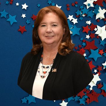 Woman smiling against a patriotic star background.