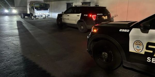 Strategic Security patrol unit coordinating with police during a nighttime response.