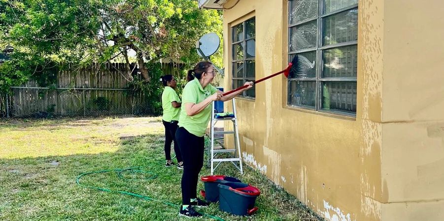 Clean and Go Team specialists performing exterior facade maintenance