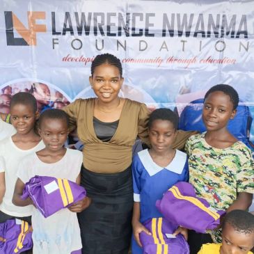 Group of children and a woman at Lawrence Nwanma Foundation event.