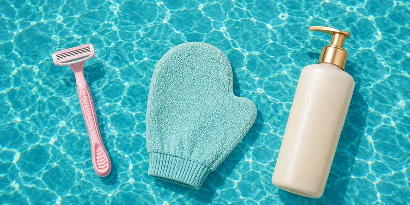 Pink razor, blue exfoliating glove, and lotion bottle on water.