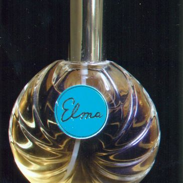 A vintage perfume bottle labeled 'Elma' with a blue circular label.