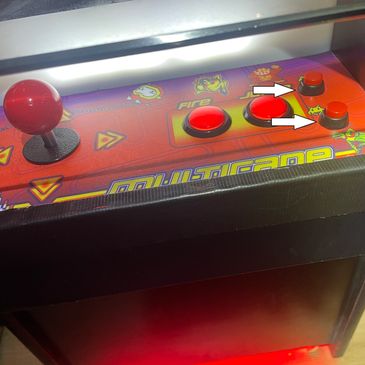 Joystick and buttons on a red arcade machine panel.