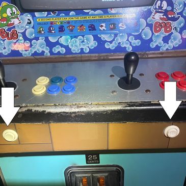 Retro arcade game control panel with joysticks and buttons.