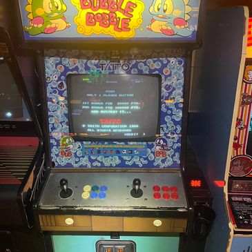 Vintage Bubble Bobble arcade machine with colorful controls.