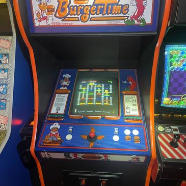 Classic BurgerTime arcade game machine with colorful graphics and joystick controls.