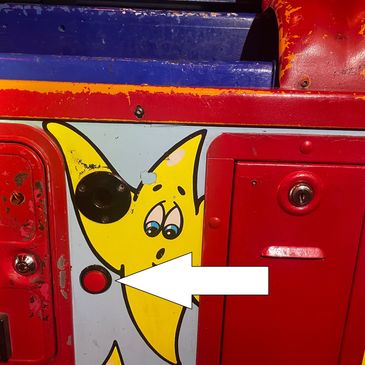 Yellow star character with a sad face on colorful metal surface.