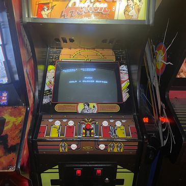 Retro arcade game cabinet with a vibrant control panel.