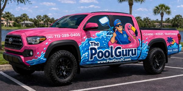 Bright pink truck advertising The Pool Guru pool cleaning service with cartoon mascot and contact info.