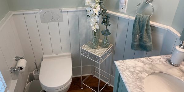 Clean and cozy bathroom corner with floral decor.