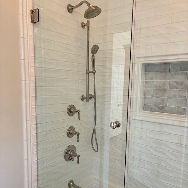 Custom walk-in shower completed in Charleston, SC featuring subway tile, frameless glass enclosure, 