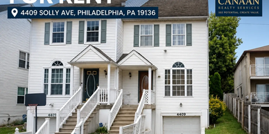 Two-story white house with dual entrances in Philadelphia.