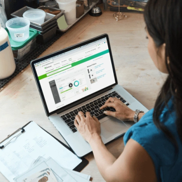 Person analyzing data on a laptop in an office.