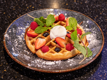 churro Waffle, coated in our Mexican style cinnamon sugar, whipped cream and mint garnish 
