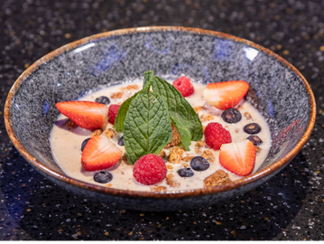 Acai base, topped with granola, raspberries, strawberries, blueberries, honey and mint 