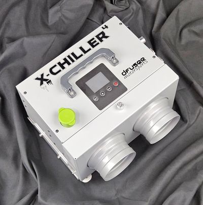 X-Chiller device on a dark cloth background.