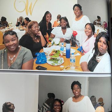 Group of women smiling around a table with food.