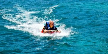 Dolphin swim adventure excursion from Cancun with iconic belly ride at Isla Mujeres.