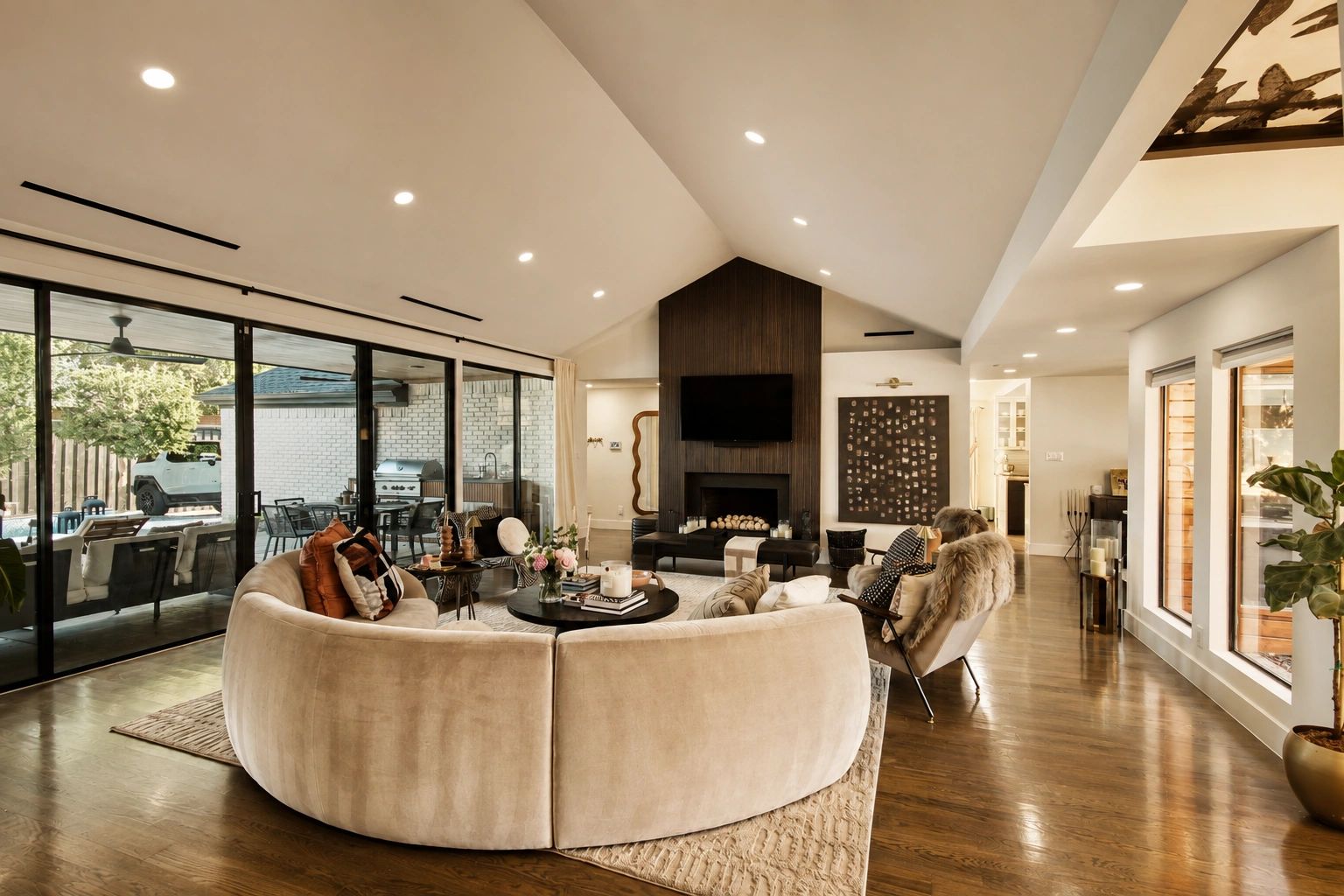 Modern living room with circular sofa and fireplace.