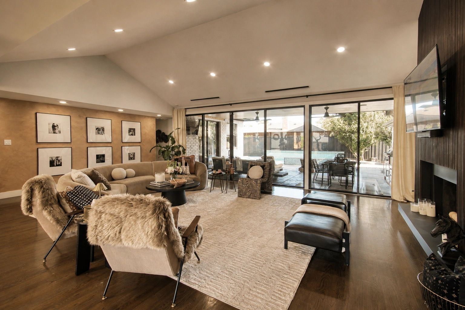 Spacious living room with modern decor and pool view.