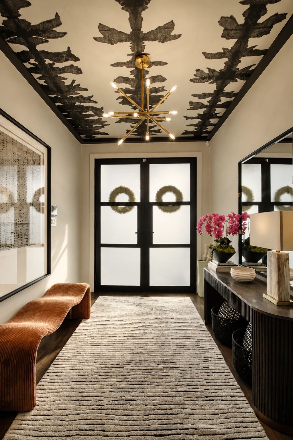 Modern hallway with decorative ceiling and curved bench.