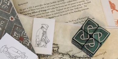 Paper illustrations and a map with a celtic knot design object.