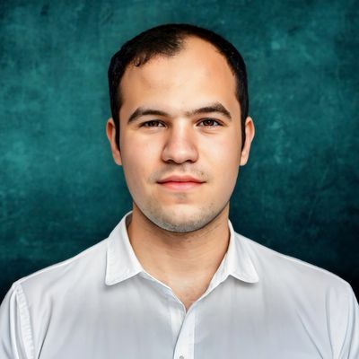 Headshot of filmmaker Max Hechtman in a white shirt, standing in front of a teal backdrop.