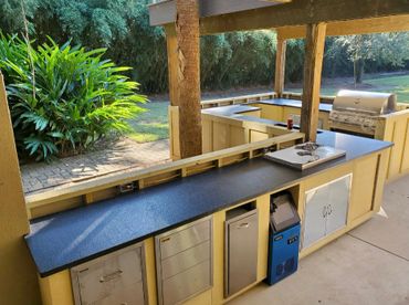 An outdoor kitchen with brushed black granite